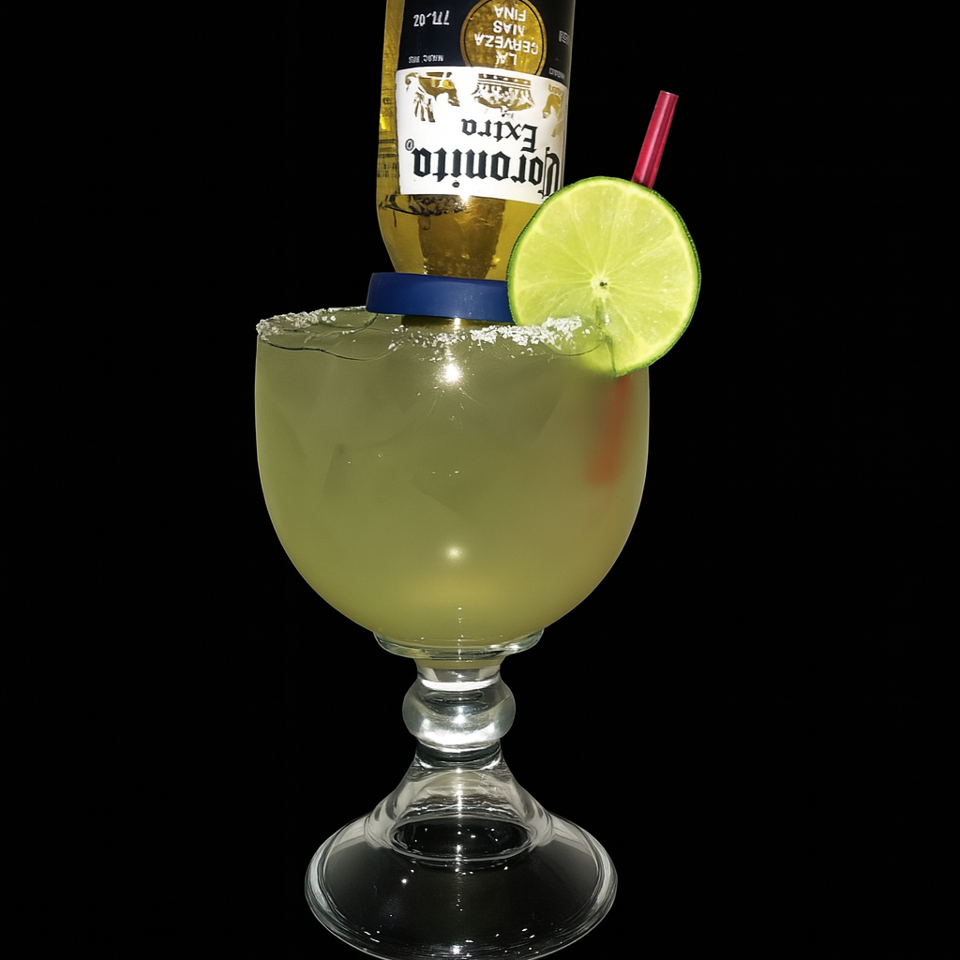A Coronarita cocktail with a Corona Extra bottle inverted into a margarita glass, garnished with a lime and salt.